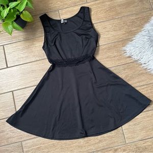Black, mini A-line dress with sheer lace detail. Size M